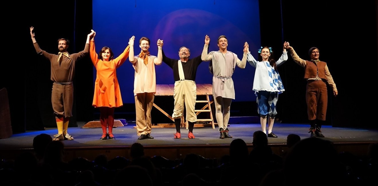 Group on stage bowing 