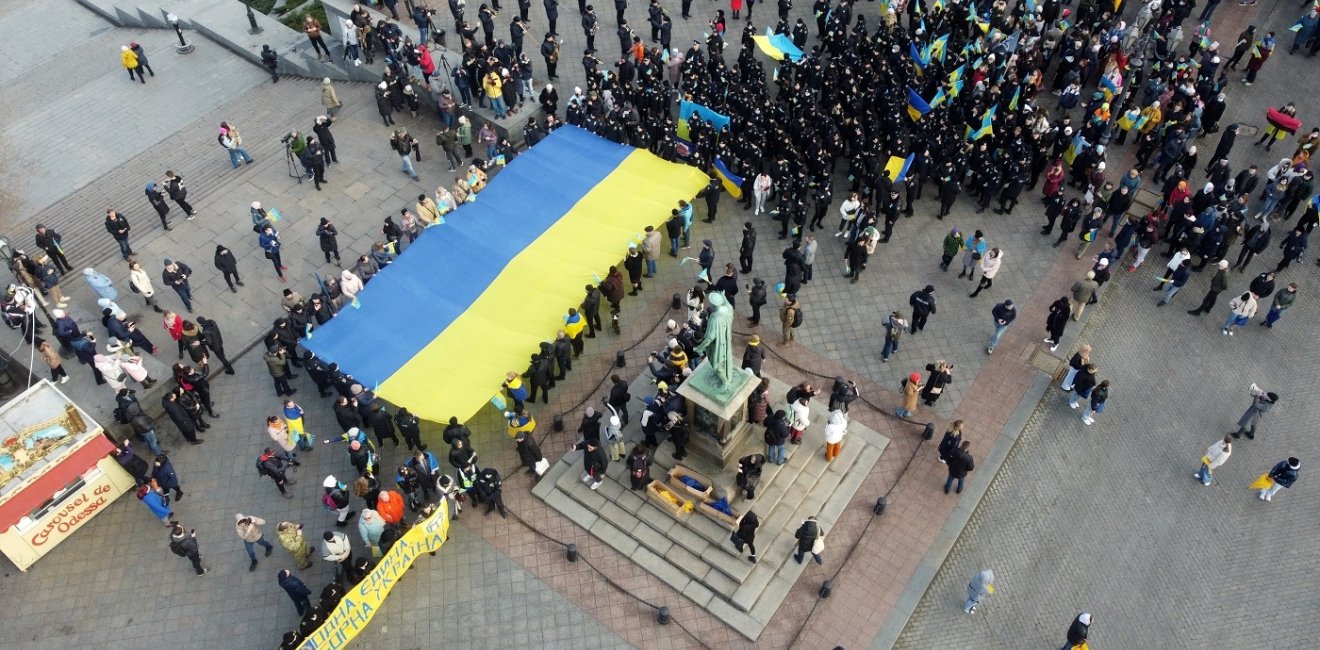 Odessa, Ukraine February,16,2022 Unity Day of Ukraine People carry a huge flag of Ukraine and Belarus near the monument to Duke de Richelieu . Taken from a drone.