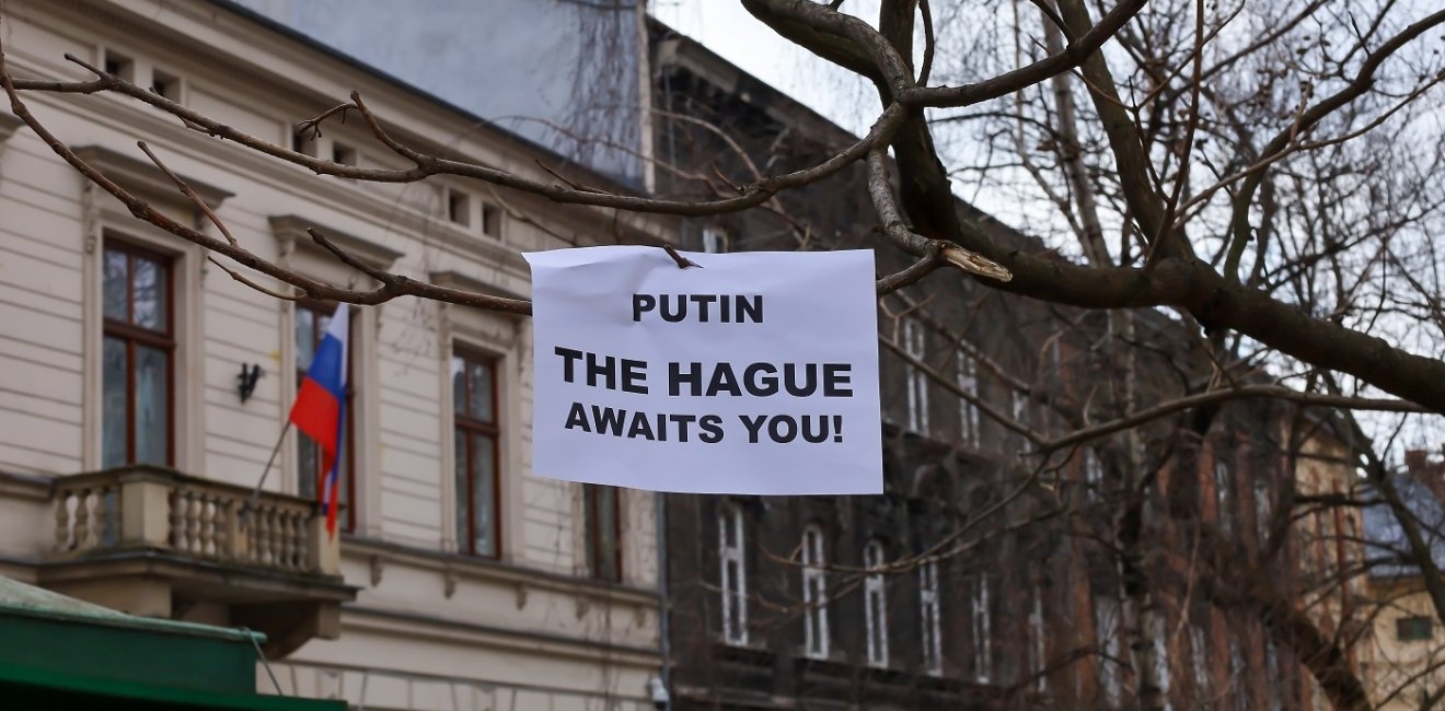 Sign that reads: "Putin the Hague Awaits you!" 