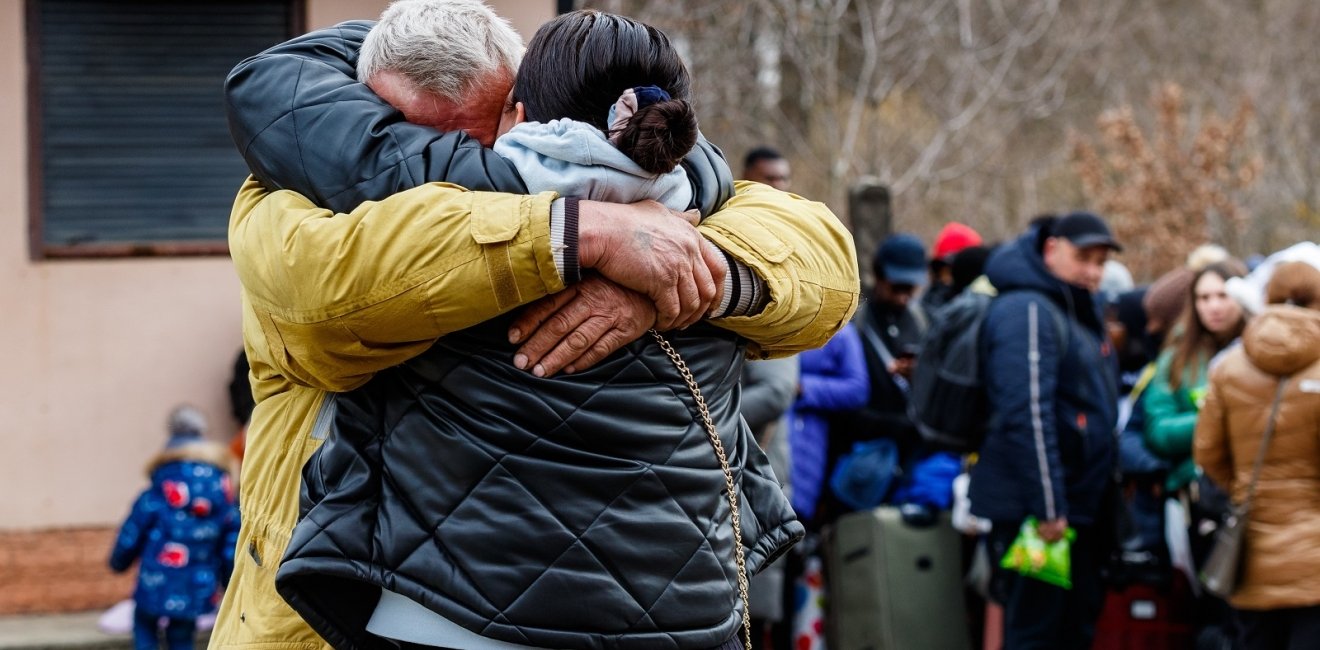 Ukrainian refugees embrace