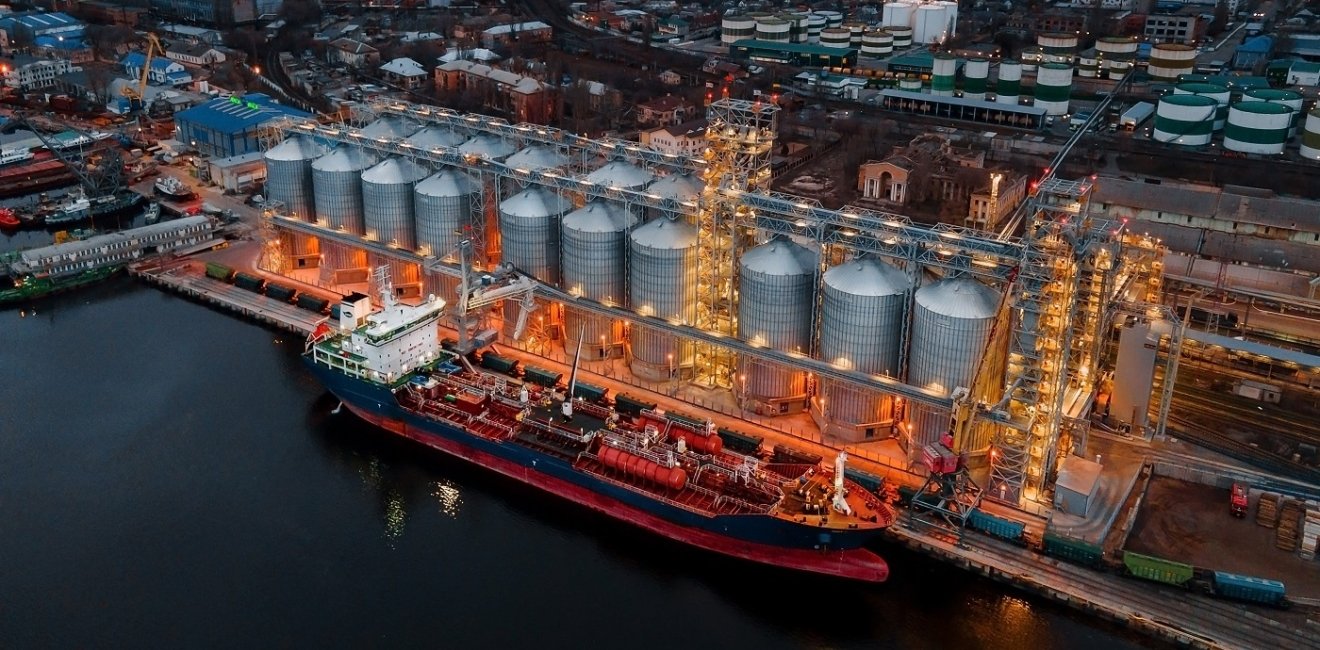 Ship at port next to large grain elevators