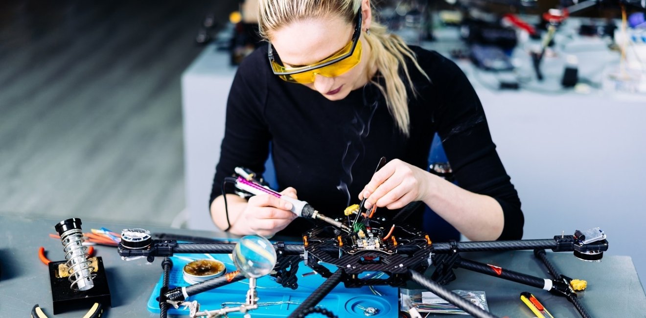 A woman engineer working on a racing drone.