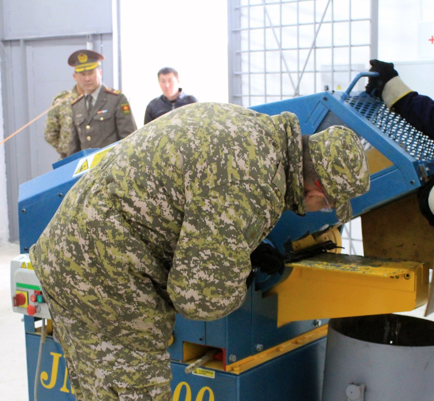 Kyrgyz military personnel demonstrate to donors the destruction of an unserviceable weapon using hydraulic shears.