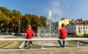  boys sit and look at the fountain in the center of Kharkiv, Ukraine