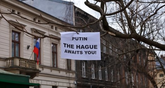 Sign that reads: "Putin the Hague Awaits you!" 