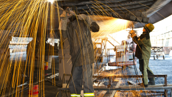 Welders working on a ship in dry dock