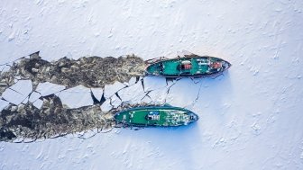 Two icebreakers breaking ice on Vistula river, Poland, 2020-02-18, aerial view