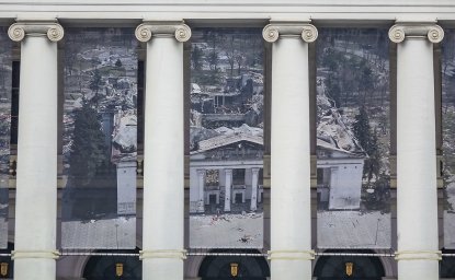 Theater facade, banner showing destroyed Mariupol Theater