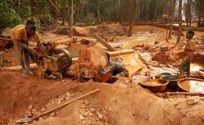 Assafo, Ivory Coast - April 3, 2024: children feeding a crusher with ore to extract some grams of gold. In Ivory Coast, children from Burkina Faso often provide cheap manpower for local businessmen