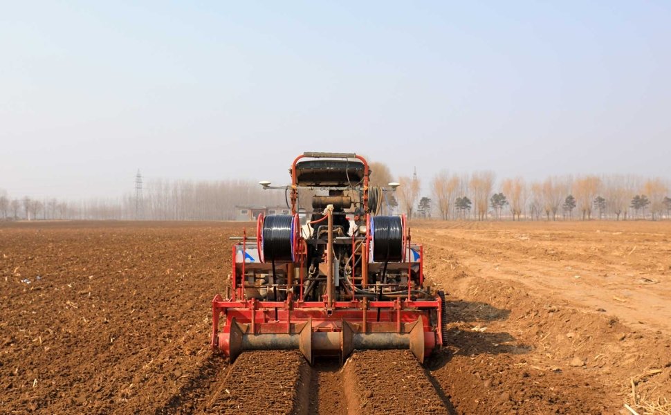 Farmer driving agricultural machinery