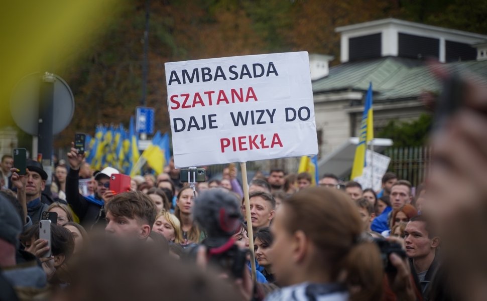 A man in Warsaw, Poland holds a sign protesting the Russian invasion of Ukraine