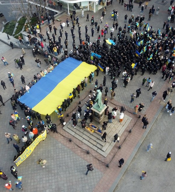 Odessa, Ukraine February,16,2022 Unity Day of Ukraine People carry a huge flag of Ukraine and Belarus near the monument to Duke de Richelieu . Taken from a drone.