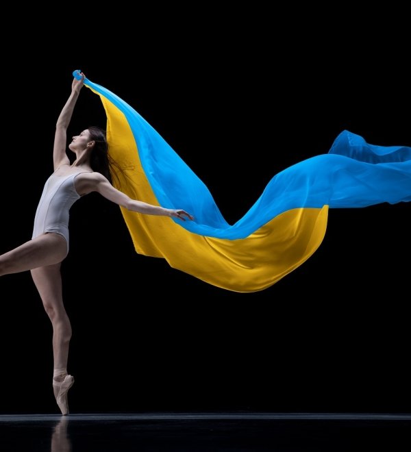 ballerina dancing with cloth painted in blue and yellow colors of Ukraine flag