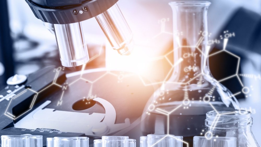 A microscope and a beaker over laid with a chemical makeup of a molecule