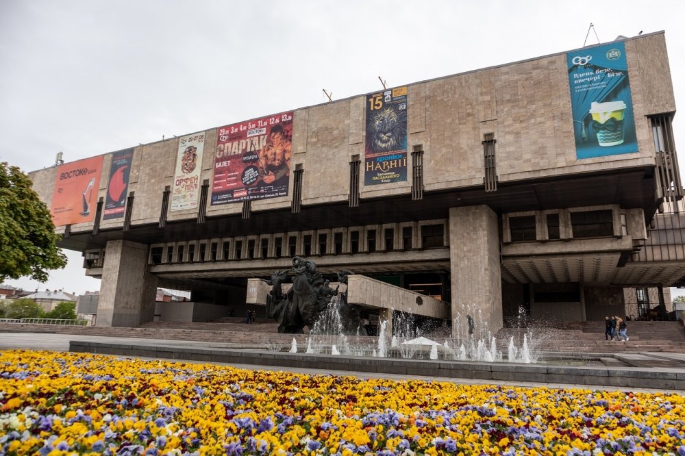 Kharkiv, Ukraine - May 08, 2021: The Kharkiv State Academic Opera and Ballet Theatre with fountains and vibrant pansies flowers blooming in spring