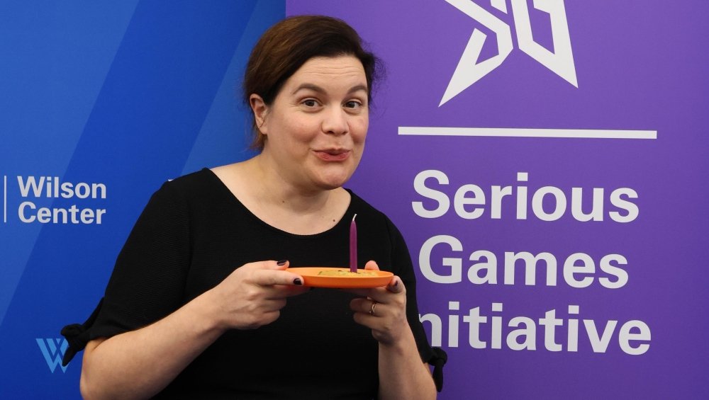 Elizabeth Newbury blowing out a candle at the Serious Games Initiative's 20th Anniversary 