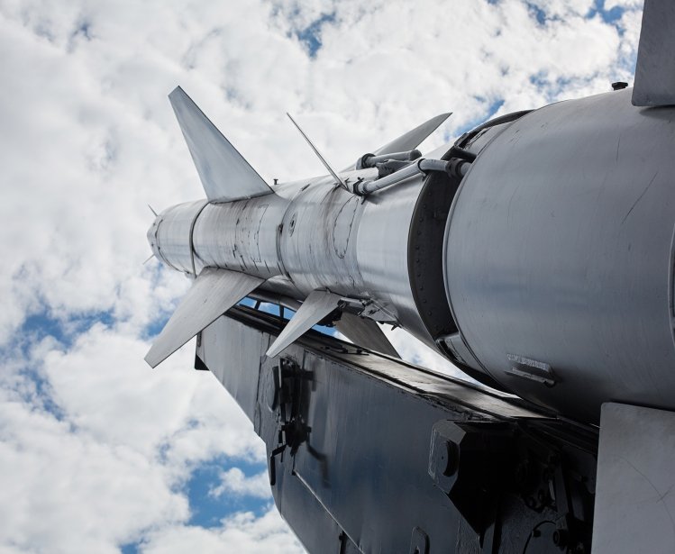 A military rocket pointed into a cloudy sky