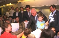 Prime Minister Yitzhak Rabin shakes hands with new Russian immigrants on their flight from Russia to Israel, April 27, 1994