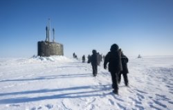 Chief of Naval Operations Adm. Lisa Franchetti walks with other distinguished visitor towards the Virginia-class fast-attack submarine USS Indiana (SSN 789) before embarking Indiana during Operation Ice Camp (ICE CAMP) 2024.