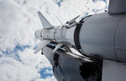 A military rocket pointed into a cloudy sky