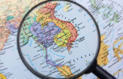 Magnifying glass over map of South East Asia
