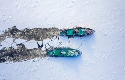 Two icebreakers breaking ice on Vistula river, Poland, 2020-02-18, aerial view