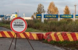 Control sign and concrete blocks at the entrance to the Ukrainian checkpoint from Russia