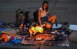 Woman making art on the street with fire