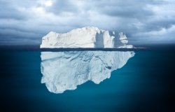 Iceberg Mostly Underwater Floating in Ocean